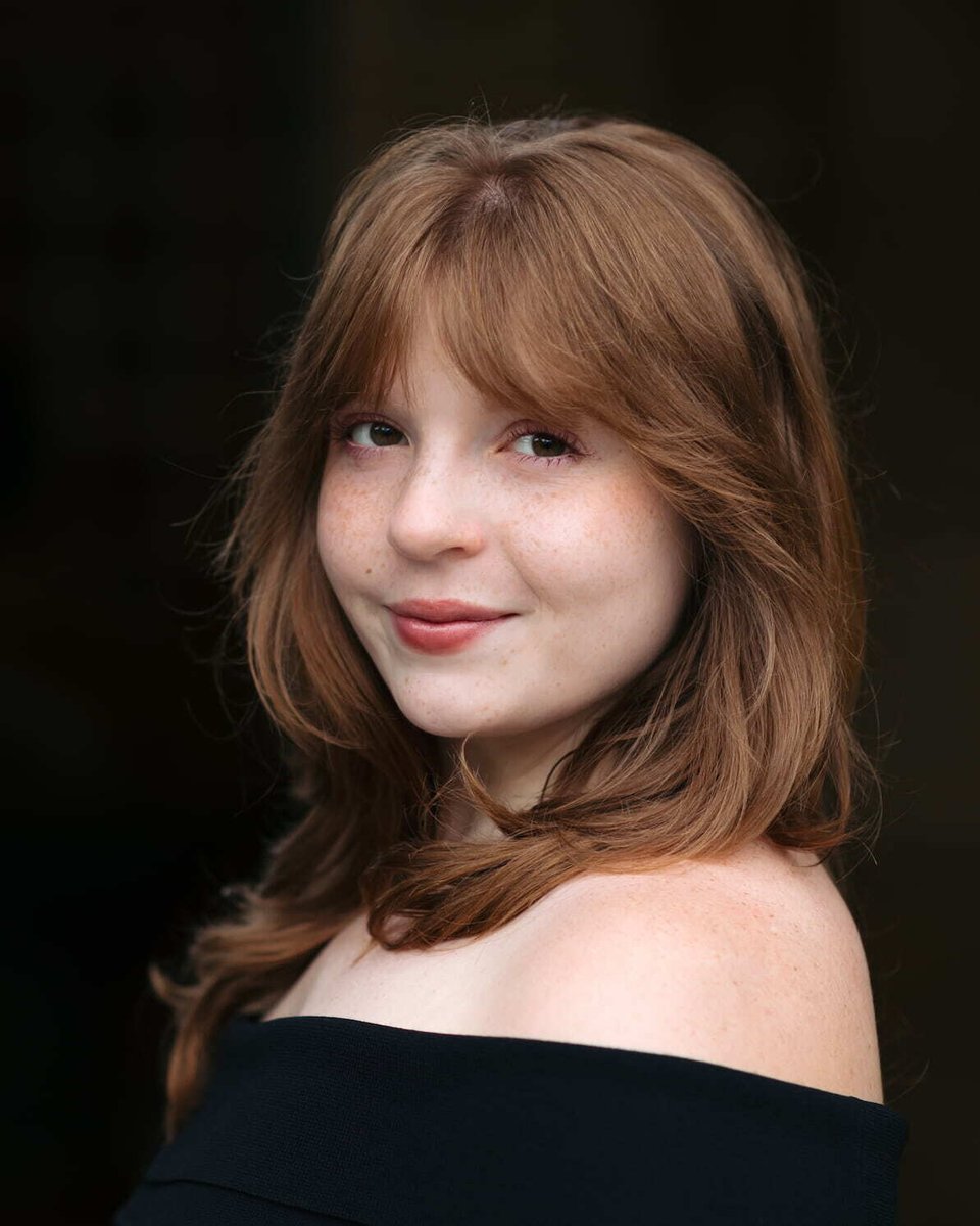 Professional musician headshot of a soprano featuring a close-up image with natural lighting, showcasing personality and expression.