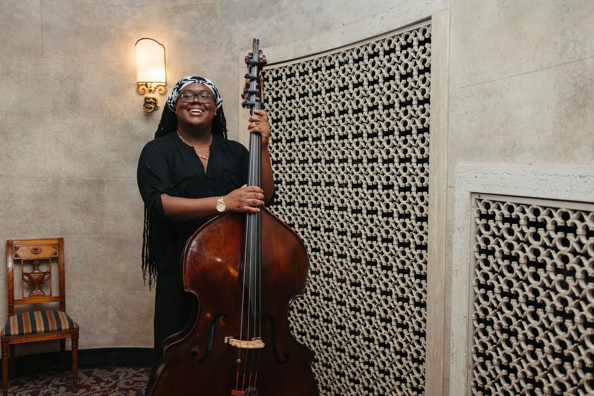 Musician portrait of a double bass player with their instrument.
